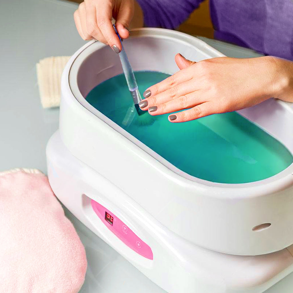 Applying Paraffin Wax with a Brush to Smooth and Soften Hands 